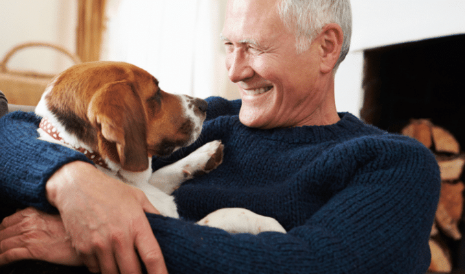 Man and dog snuggling