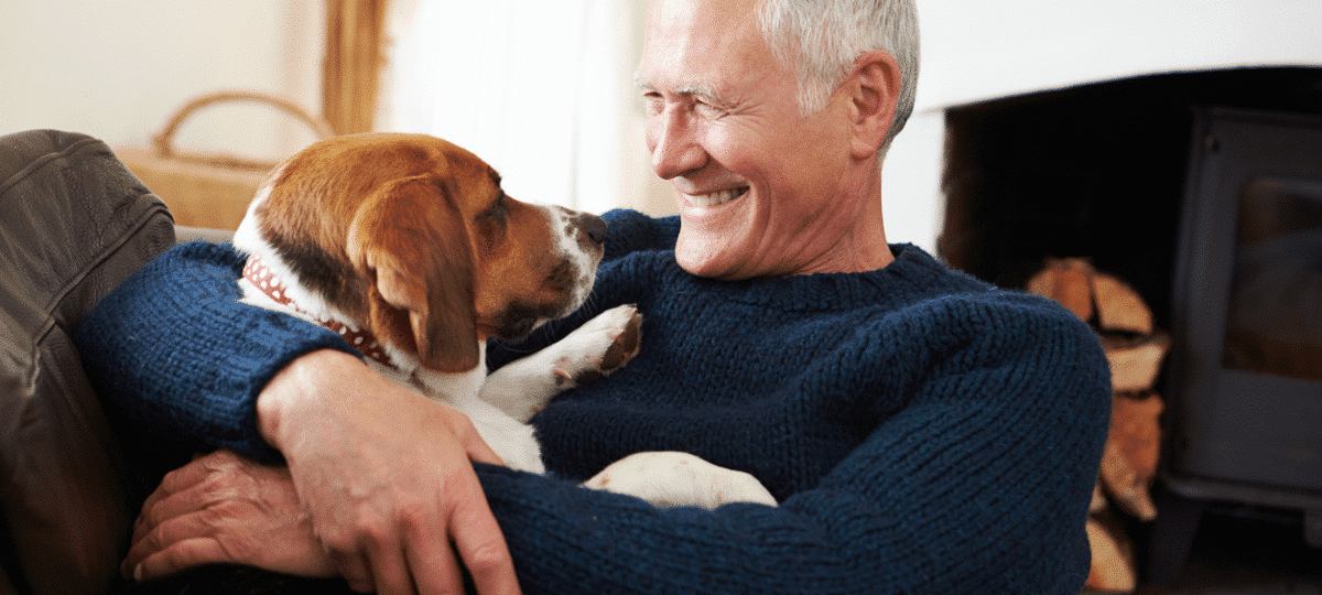 Man and dog snuggling