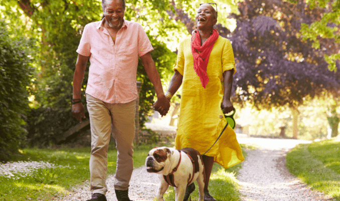 Older couple walking their dog