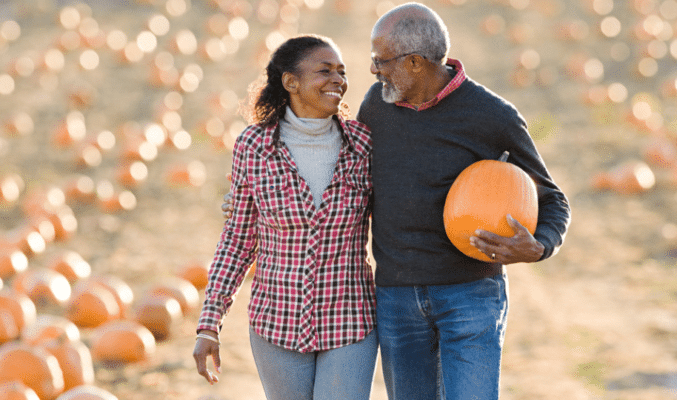 Couple walking in pumpkin patch