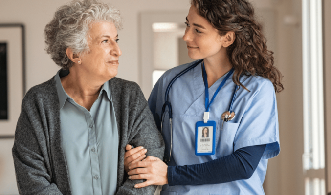 Older woman walking with nurse