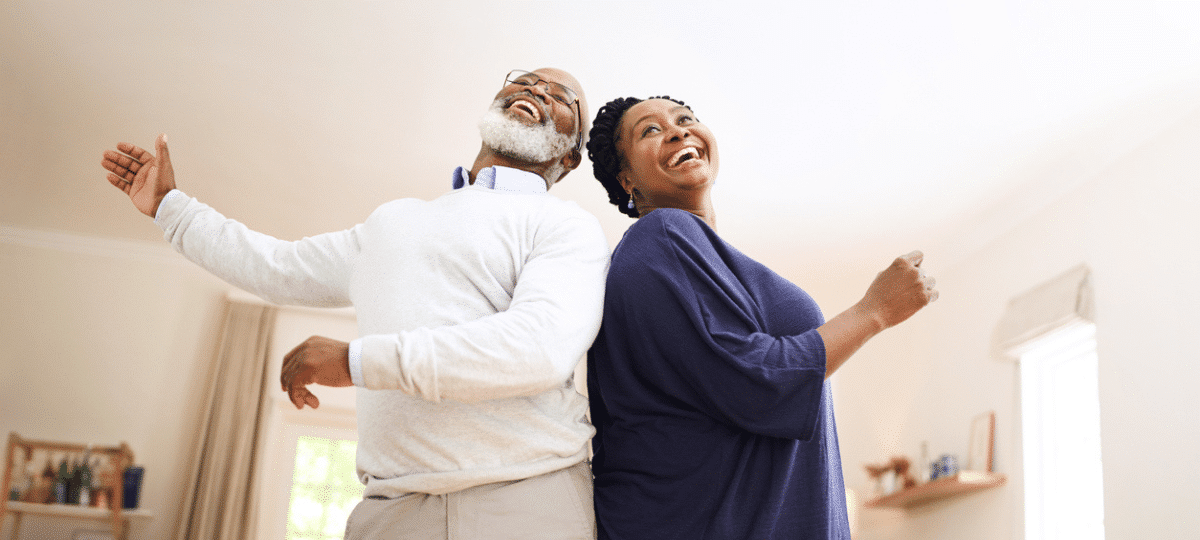 Senior couple dancing in living room